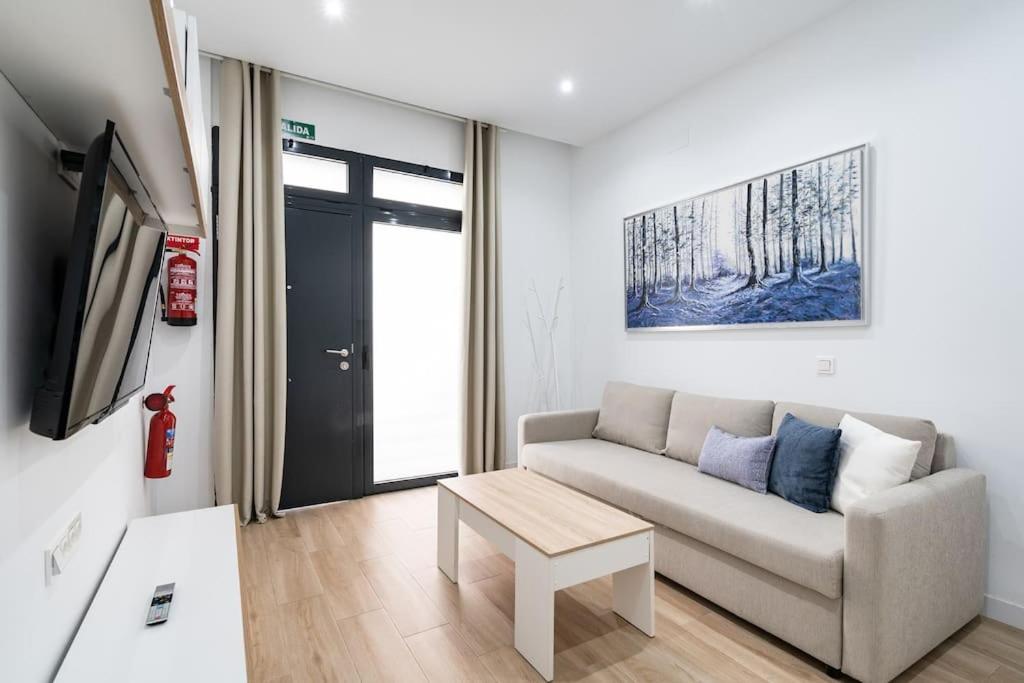 a living room with a couch and a table at Apartamento acogedor y cómodo GUAD-C in Madrid