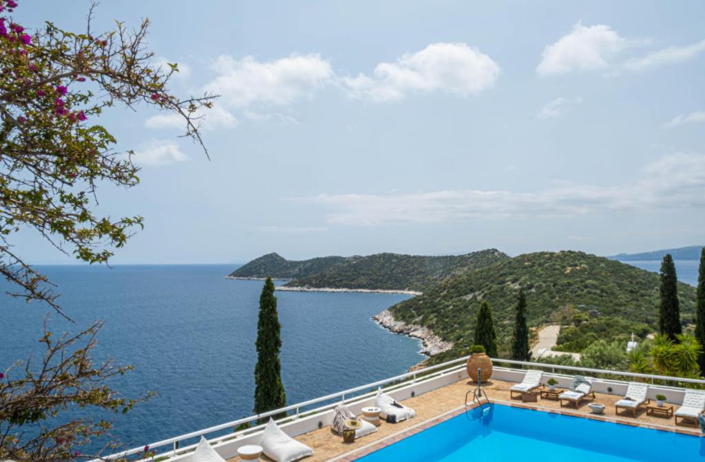a view of the ocean from a resort with a swimming pool at Villa Artisti Marathon in Marathón