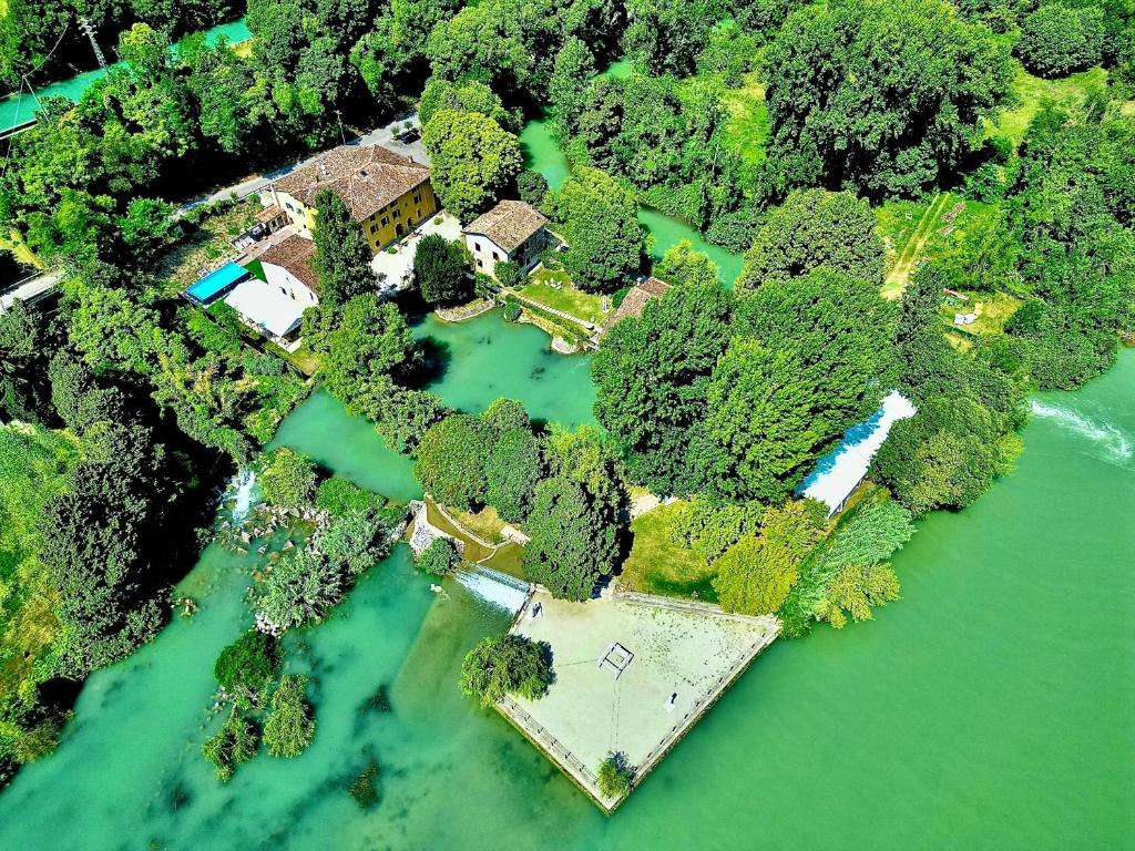 an aerial view of a house in the middle of a river at Villa dei Mulini in Volta Mantovana