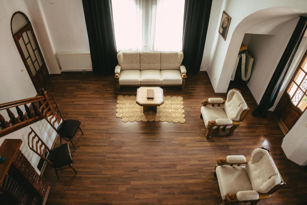 an overhead view of a living room with a couch and chairs at Turnul Maresalului in Corbeni