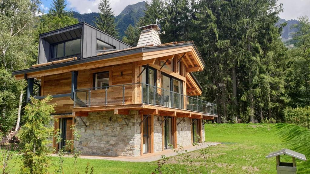a house with a wrap around balcony on top of it at Black Pearl in Chamonix