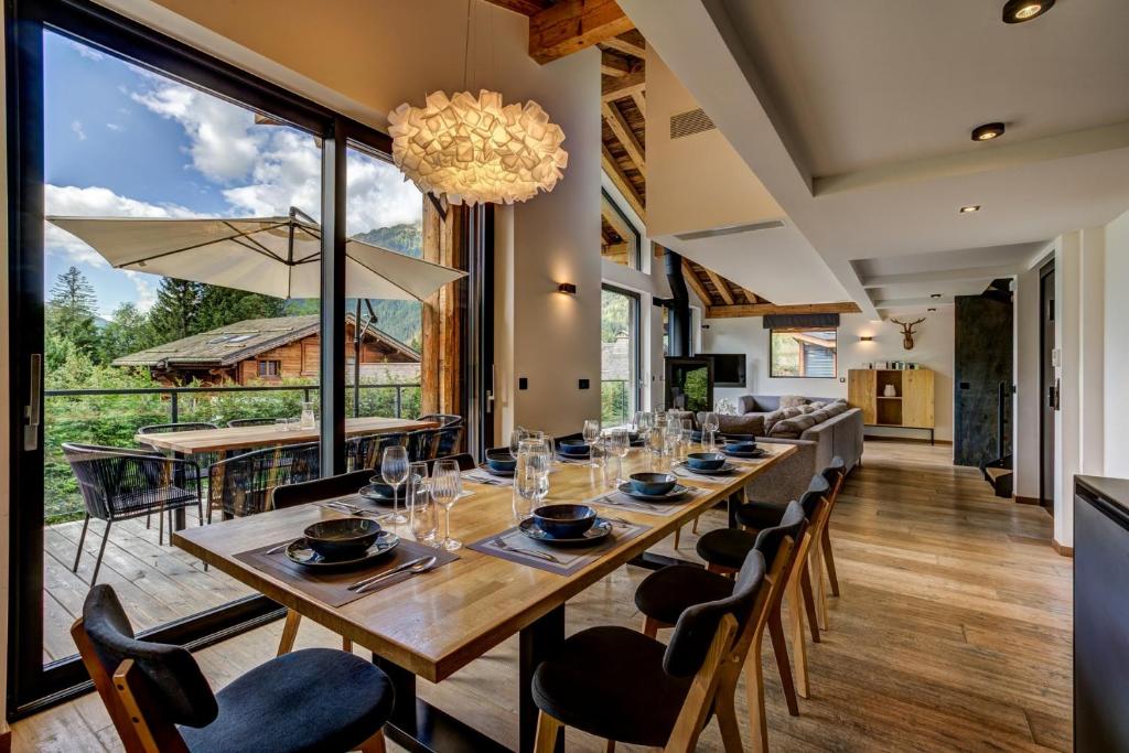une grande salle à manger avec une longue table et des chaises dans l'établissement Black Pearl, à Chamonix-Mont-Blanc
