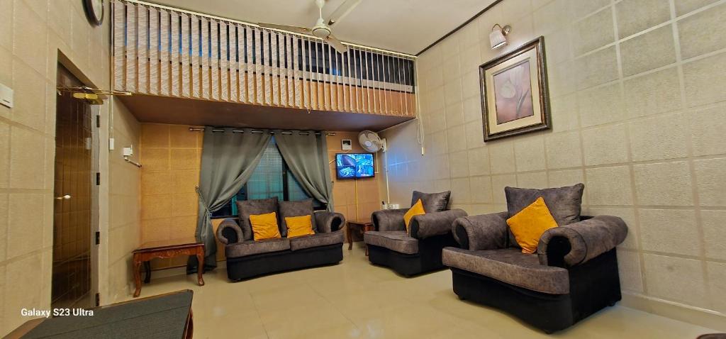 a living room with two couches and a tv at UDUPI HOMESTAY - Garden Villa 5BHK in Udupi