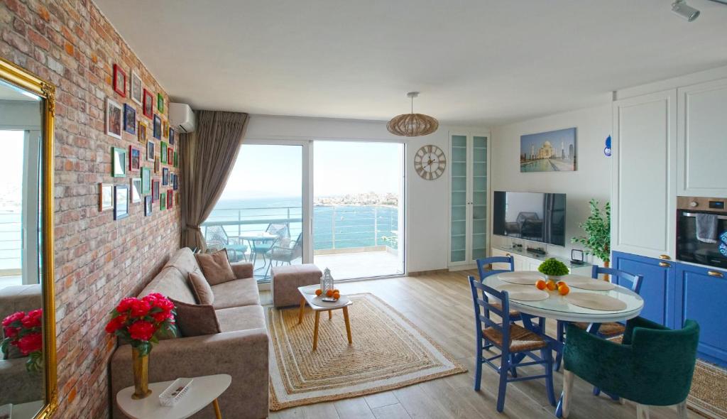 a living room with a couch and a table at Blue Eye Apartment in Sarandë