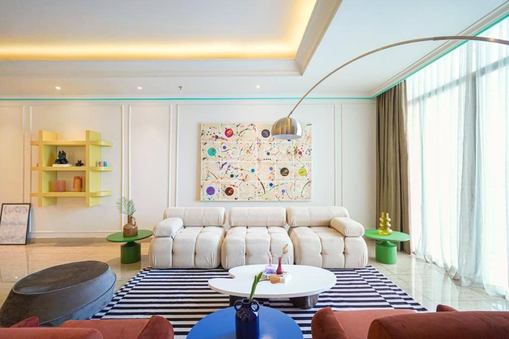 a living room with a couch and a table at Sonar Paraiso: A Dreamy Apartment in Jakarta in Madiun