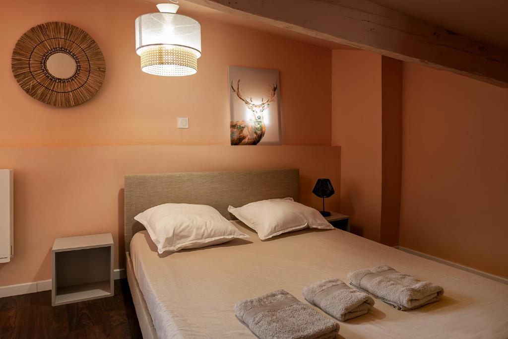 a bedroom with a bed with two towels on it at Perpignan - Appartement en centre ville in Perpignan