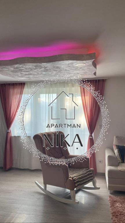 a living room with a chair and a swing at Apartman Nika in Pale