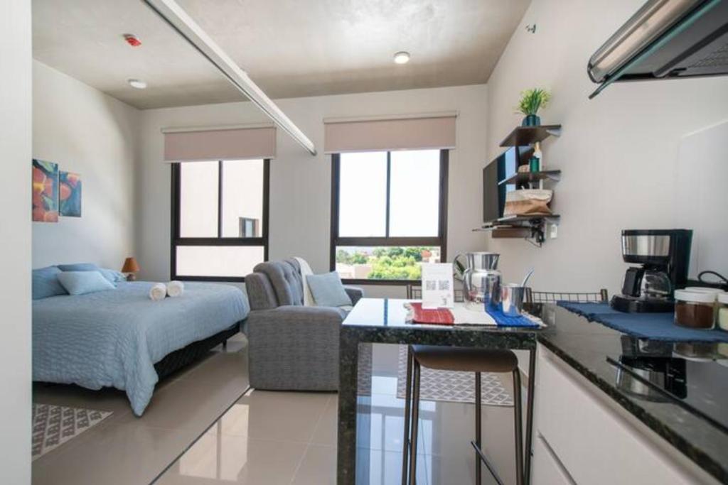 cocina y sala de estar con cama y mesa en Delicado Monoambiente-comfy Studio en Luque