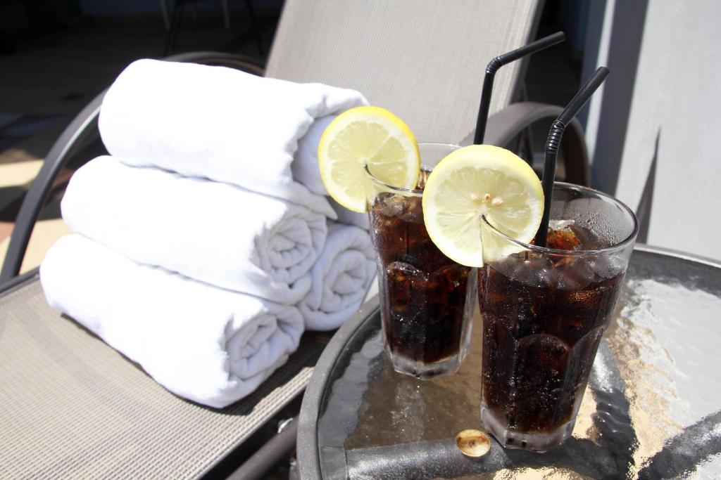 two drinks on a tray with towels and lemon slices at Badi'ah Hotel in Bandar Seri Begawan