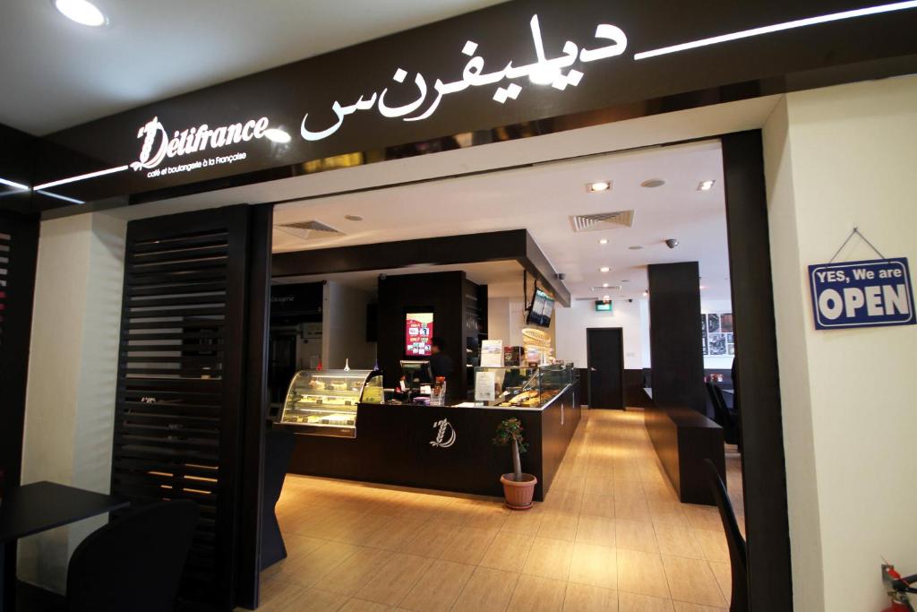 a restaurant with a sign on the front of a store at Badi'ah Hotel in Bandar Seri Begawan