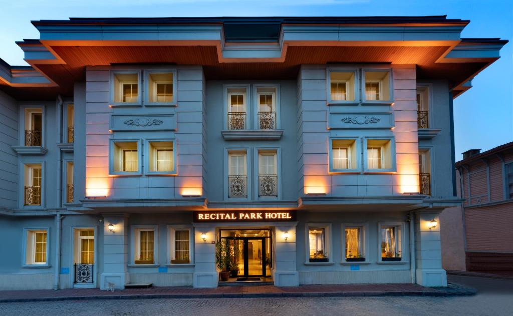 a large white building with lights on at Recital Park Hotel in Istanbul