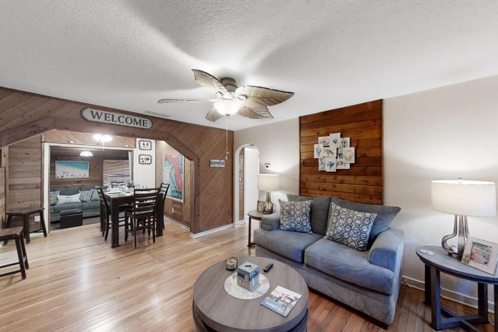 a living room with a couch and a table at Jupiter Pines Cottage in Clearwater
