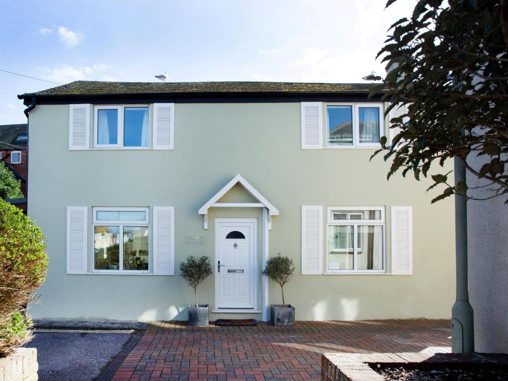 a white house with a white door and windows at York Cottage in Sidmouth