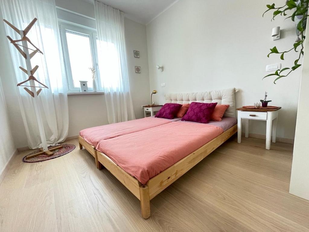 a bedroom with a large bed with purple pillows at Private apartment in Usha studio in Ljubljana