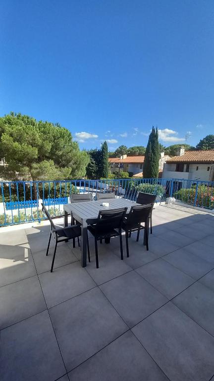 a picnic table and chairs on a patio at La colombe in Argelès-sur-Mer