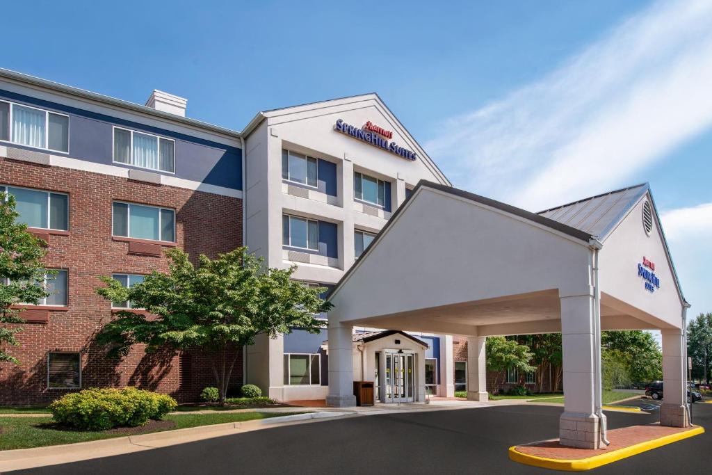 a rendering of a hotel with a large building at SpringHill Suites Herndon Reston in Herndon