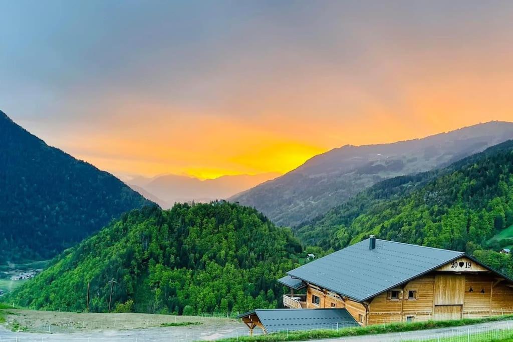 a cabin in the mountains with the sunset in the background at Appartement en Montagne in Beaufort