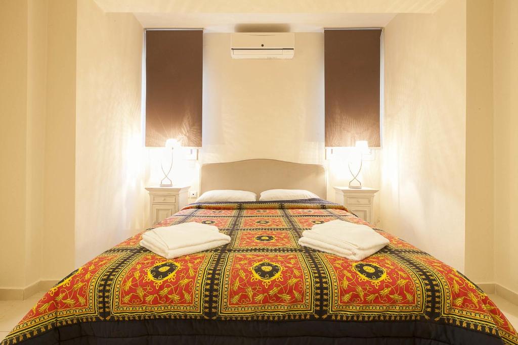 a bedroom with a bed with two pillows on it at Sunny Hill in Sani Beach
