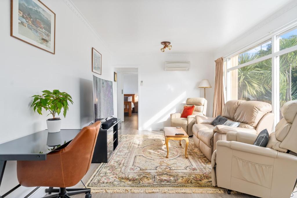 a living room with a couch and a table at Sunny Beach Holiday Home 80 in Kingston Beach