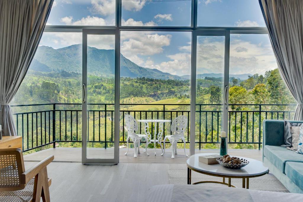 a living room with a view of the mountains at Waterfall Villa by Opulence in Talawakele