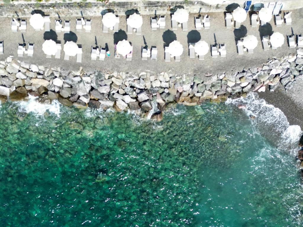 an aerial view of a beach with chairs and water at Villaggio Smeraldo in Moneglia