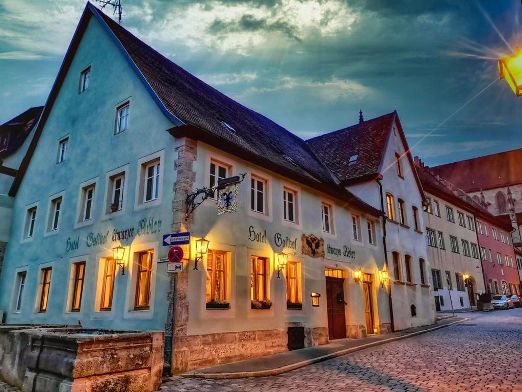 un edificio azul y blanco en una calle en Hotel Schwarzer Adler en Rothenburg ob der Tauber