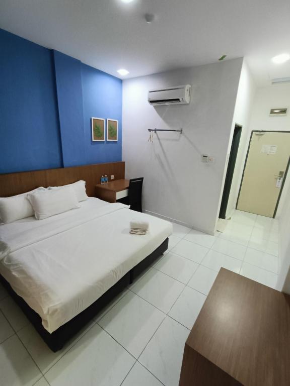 Postel nebo postele na pokoji v ubytování Hotel Wawasan