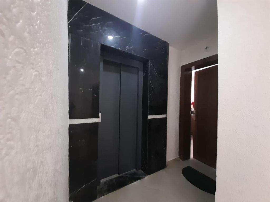 a hallway with a black door in a room at Appartement plage Mehdia in Plage de Mehdia