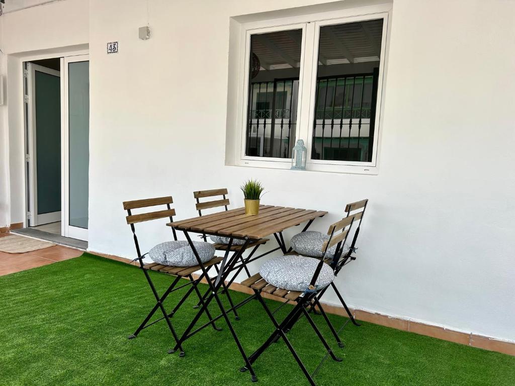 a table and chairs on a patio with grass at CASA LALA by Liamar in Playa Honda
