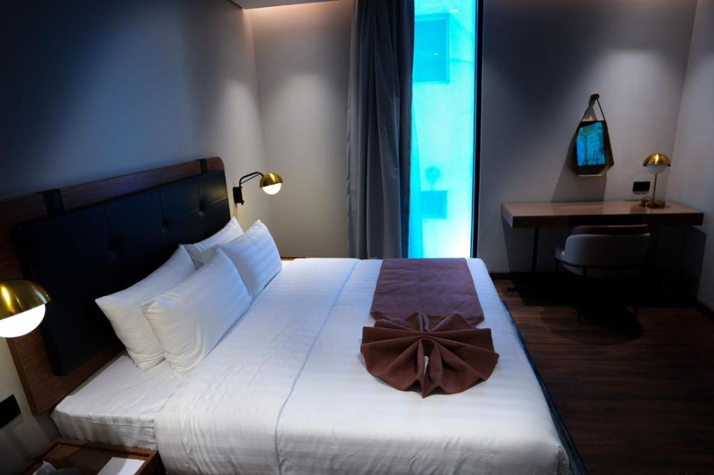 Postel nebo postele na pokoji v ubytování NAS Hotel
