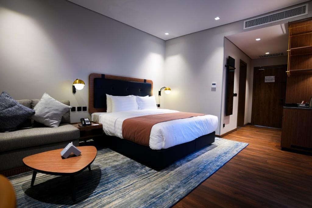 Postel nebo postele na pokoji v ubytování NAS Hotel