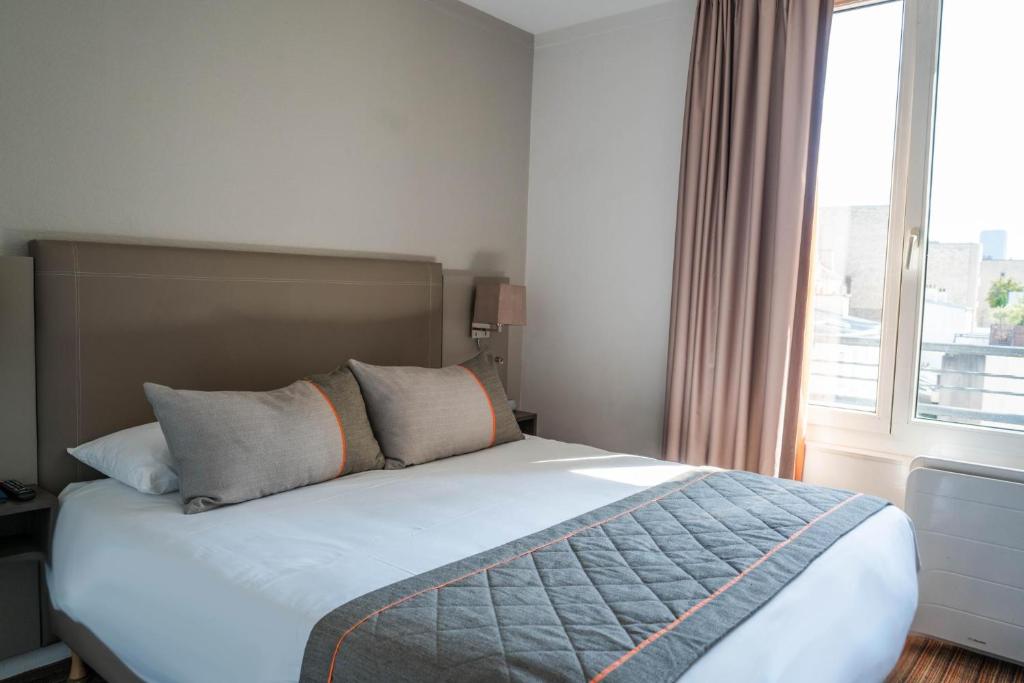 Postel nebo postele na pokoji v ubytování Timhotel Tour Eiffel