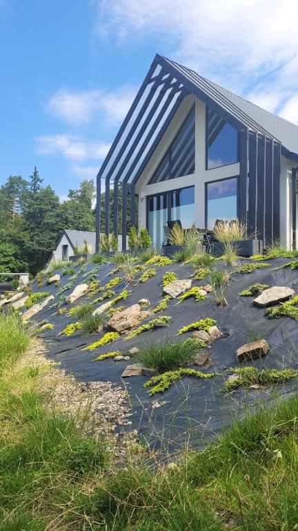 una casa in cima a una collina con i fiori di Cichosfera- Dom w Dusznikach-Zdrój a Duszniki Zdrój