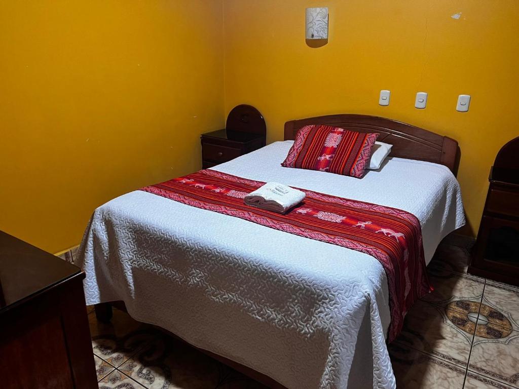 Postel nebo postele na pokoji v ubytování Hotel Colquewasi