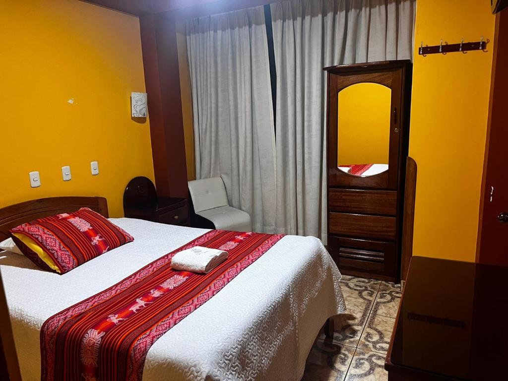 Postel nebo postele na pokoji v ubytování Hotel Colquewasi