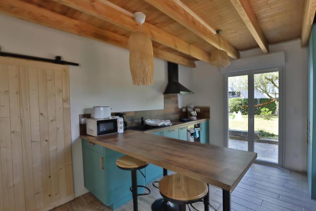 a kitchen with a wooden counter top in a room at Gîte Louannec - Ty Bleiz in Louannec