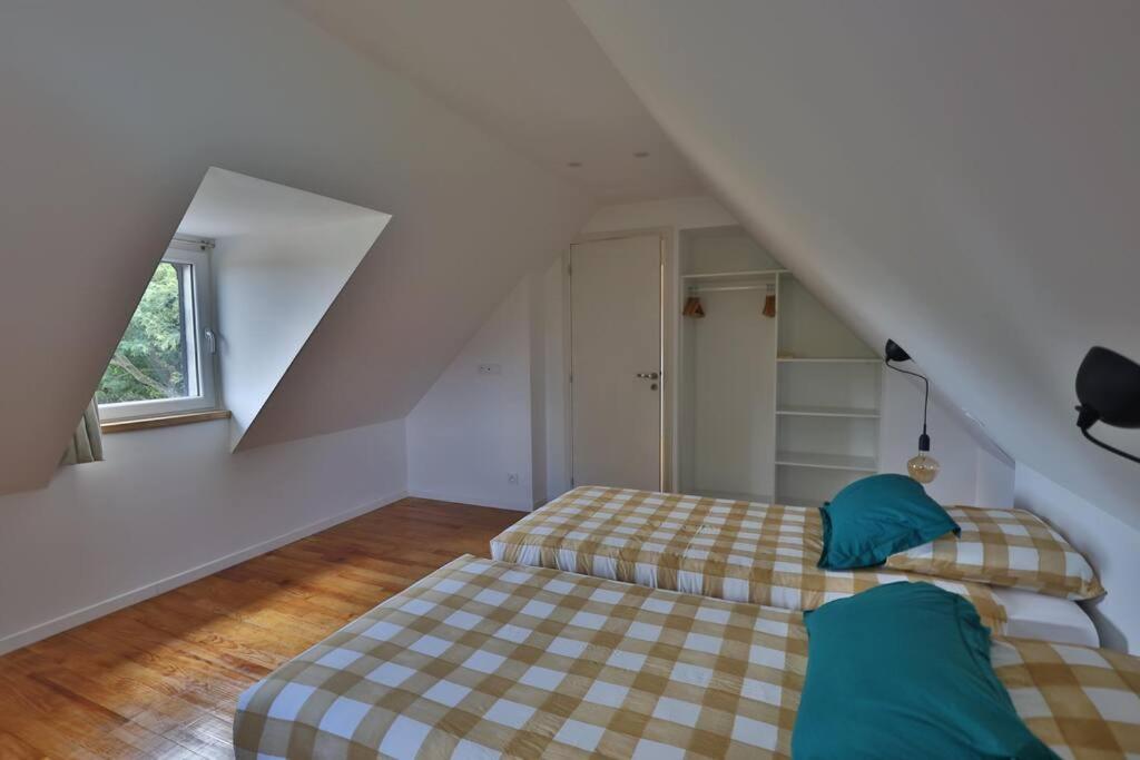 a bedroom with two beds in a attic at Gîte Louannec - Ty Bleiz in Louannec
