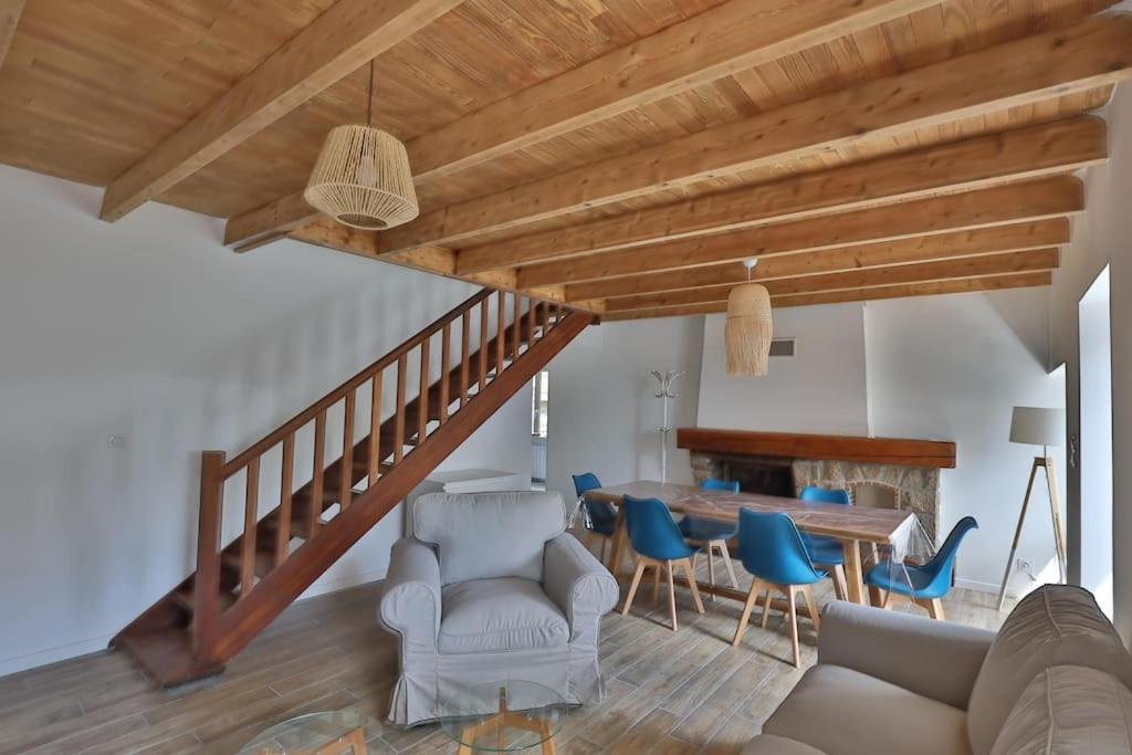 a living room with a table and blue chairs at Gîte Louannec - Ty Bleiz in Louannec