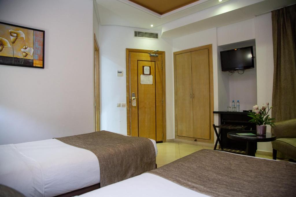 Postel nebo postele na pokoji v ubytování Malak Hotel