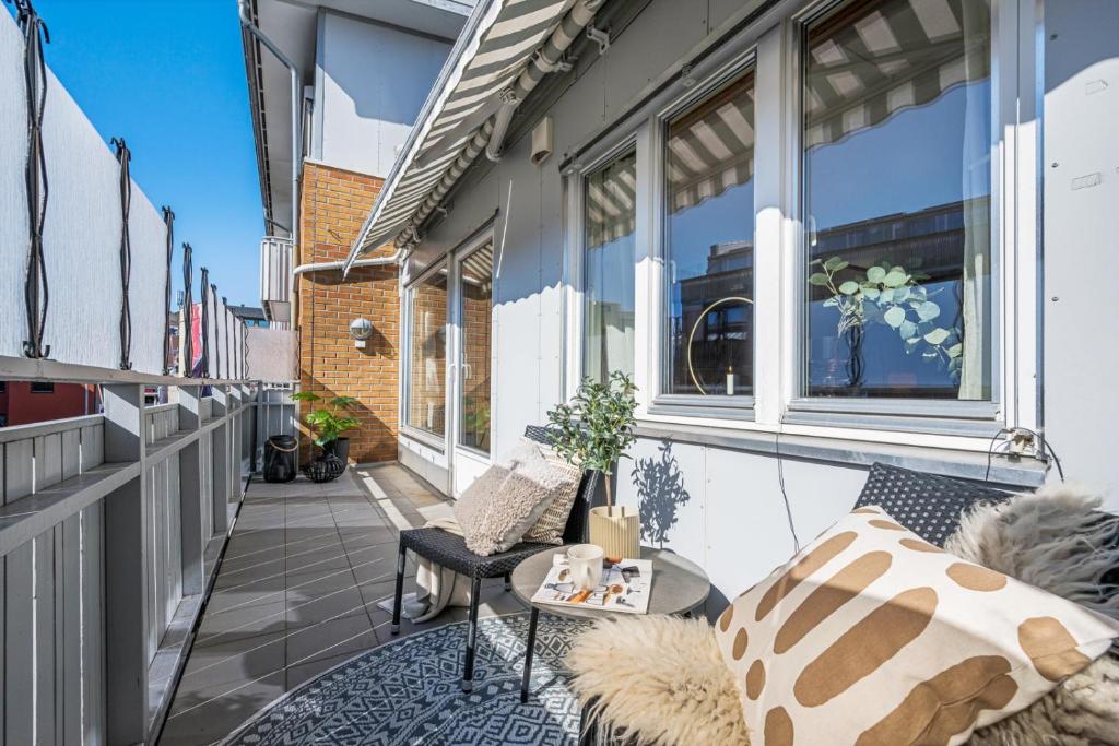 a balcony with a chair and a table on a building at Horten center in Horten