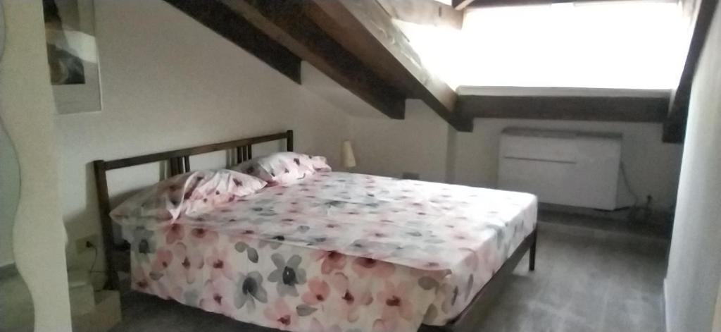 ein Schlafzimmer mit einem Bett in einem Zimmer mit einem Fenster in der Unterkunft Freetime Trieste in Triest