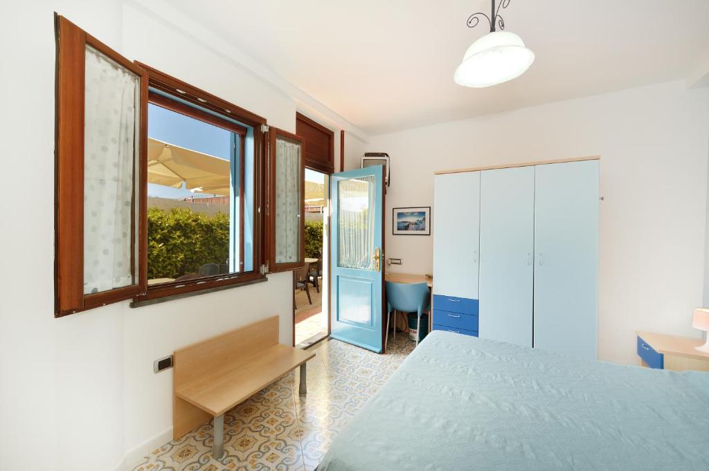 a bedroom with a bed and a window at La Capannina in Procida