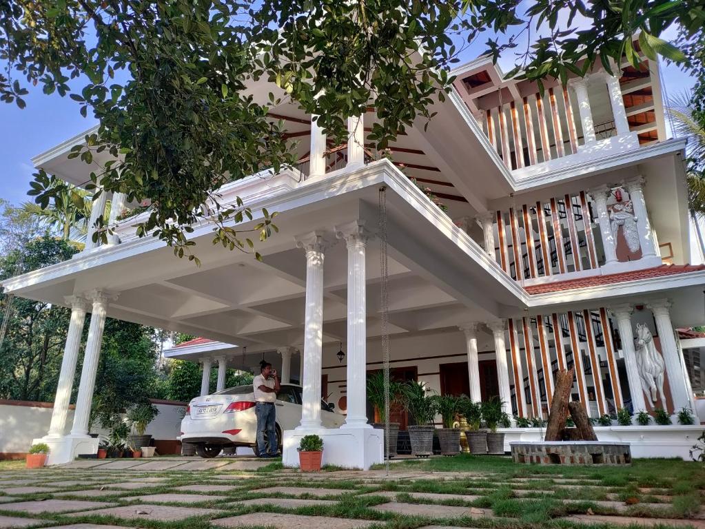 a woman standing in front of a house at The Cana's Coorg in Ammatti