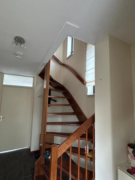 a winding staircase in a house with a stair case at Cairo in Almere