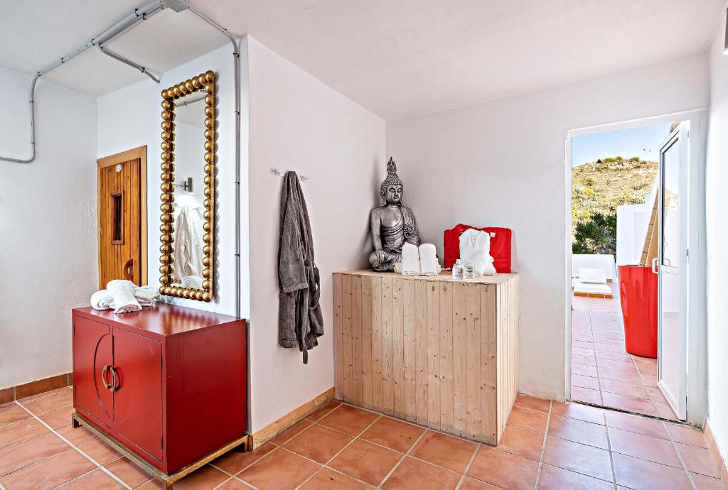 a room with a red dresser and a mirror at Apartamentos Dulcemar Frente al Mar con zona SPA in San José