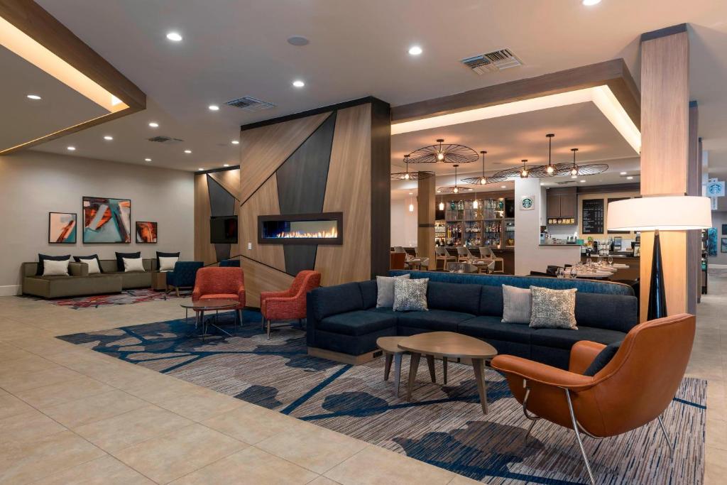 a lobby of a hotel with a couch and chairs at Delta Hotels by Marriott Grand Rapids Airport in Grand Rapids