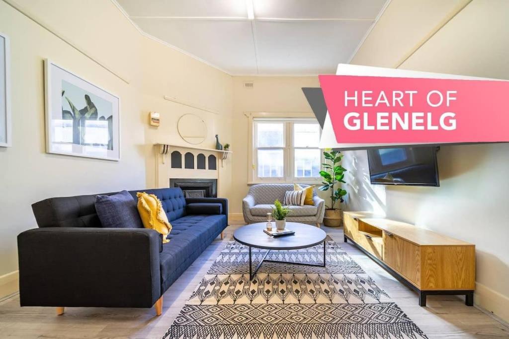 a living room with a couch and a sign that reads heart of cleveland at Sea La Vie on Durham in Glenelg