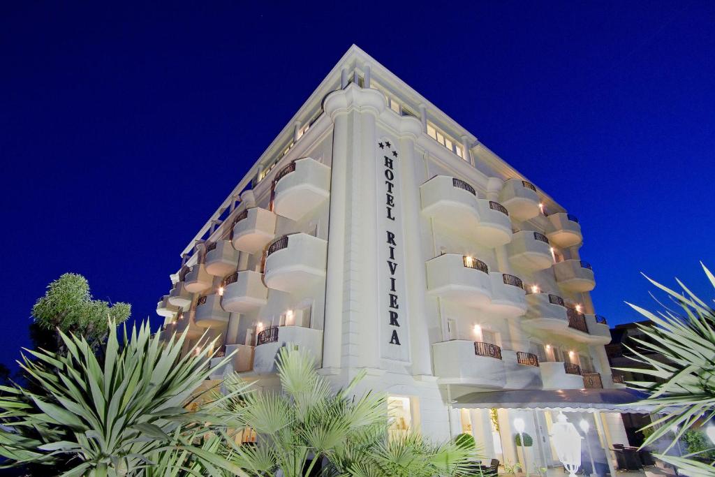 a large white building with the words grand hotel at Hotel Riviera in Milano Marittima