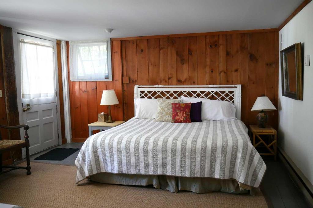 a bedroom with a large bed with wooden walls at Race Brook Lodge in Sheffield