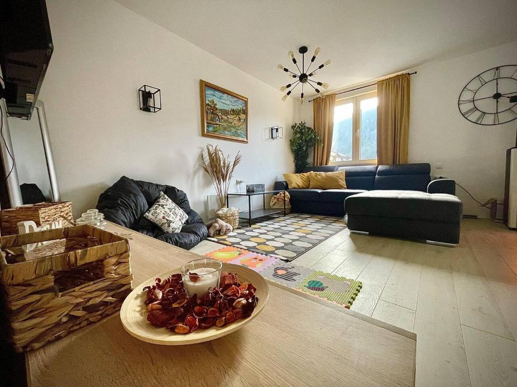 a living room with a bowl of fruit on a table at VILA MASLACAK in Popovići